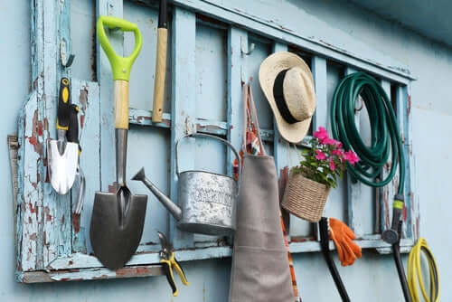 Rustic wooden garden tool rack with implements for winter maintenance